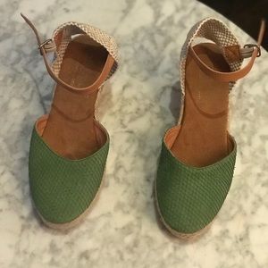 Wedge shoe with ankle straps.